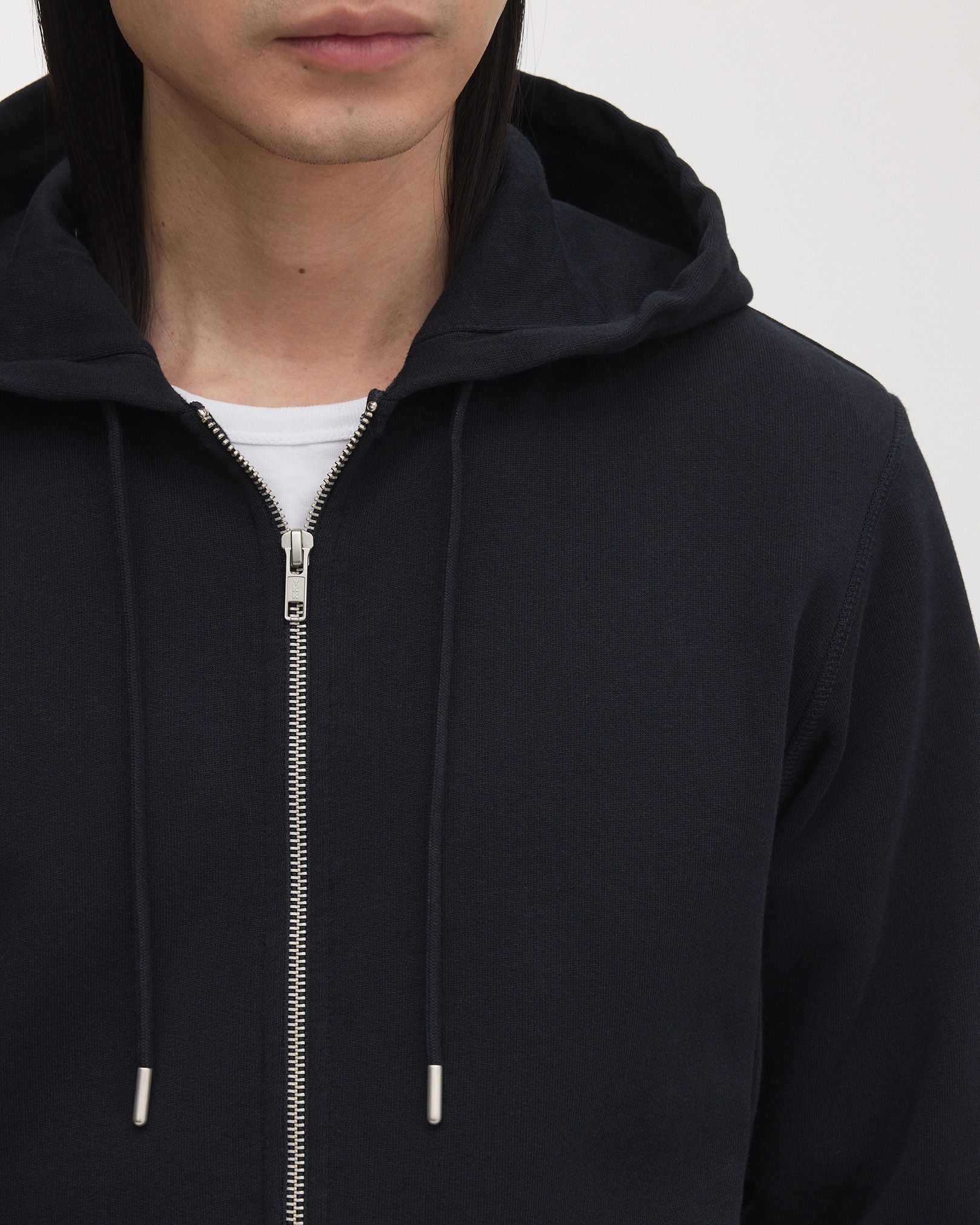 Double lined hood, with tonal drawstrings and brushed metal details
